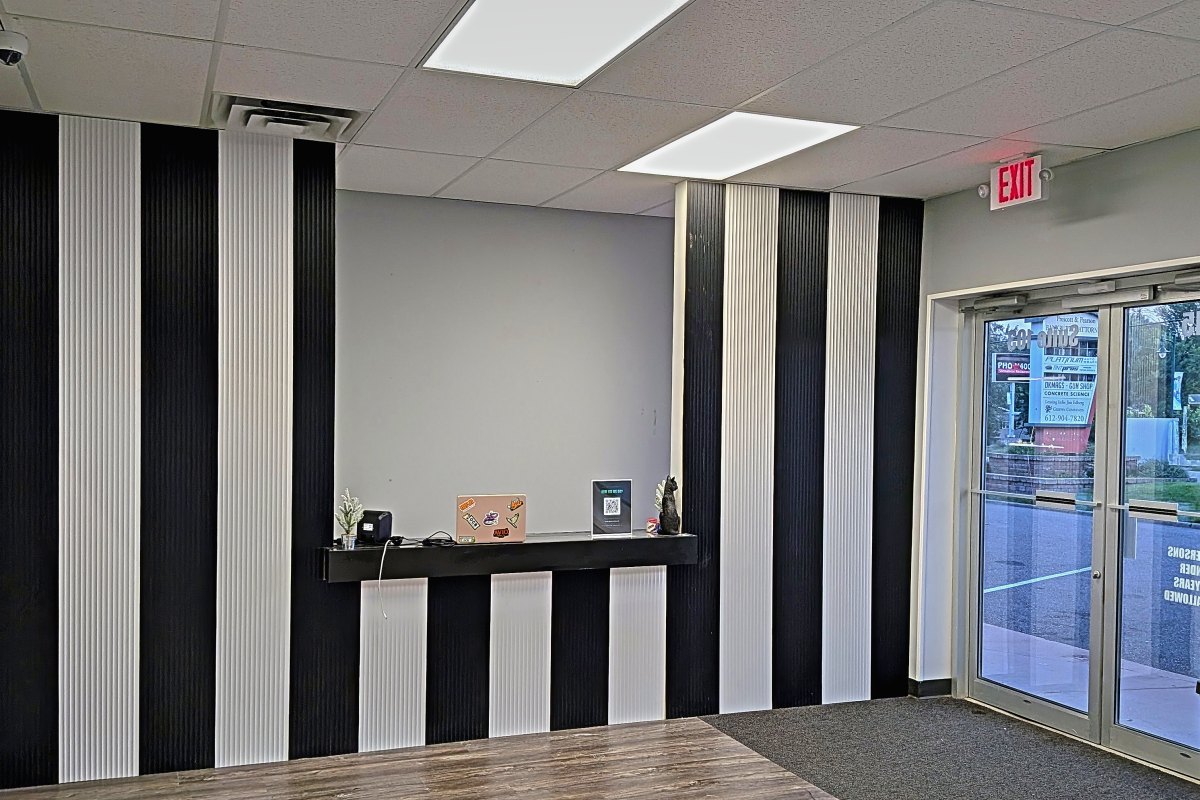 Reception area with slatted black and white feature wall